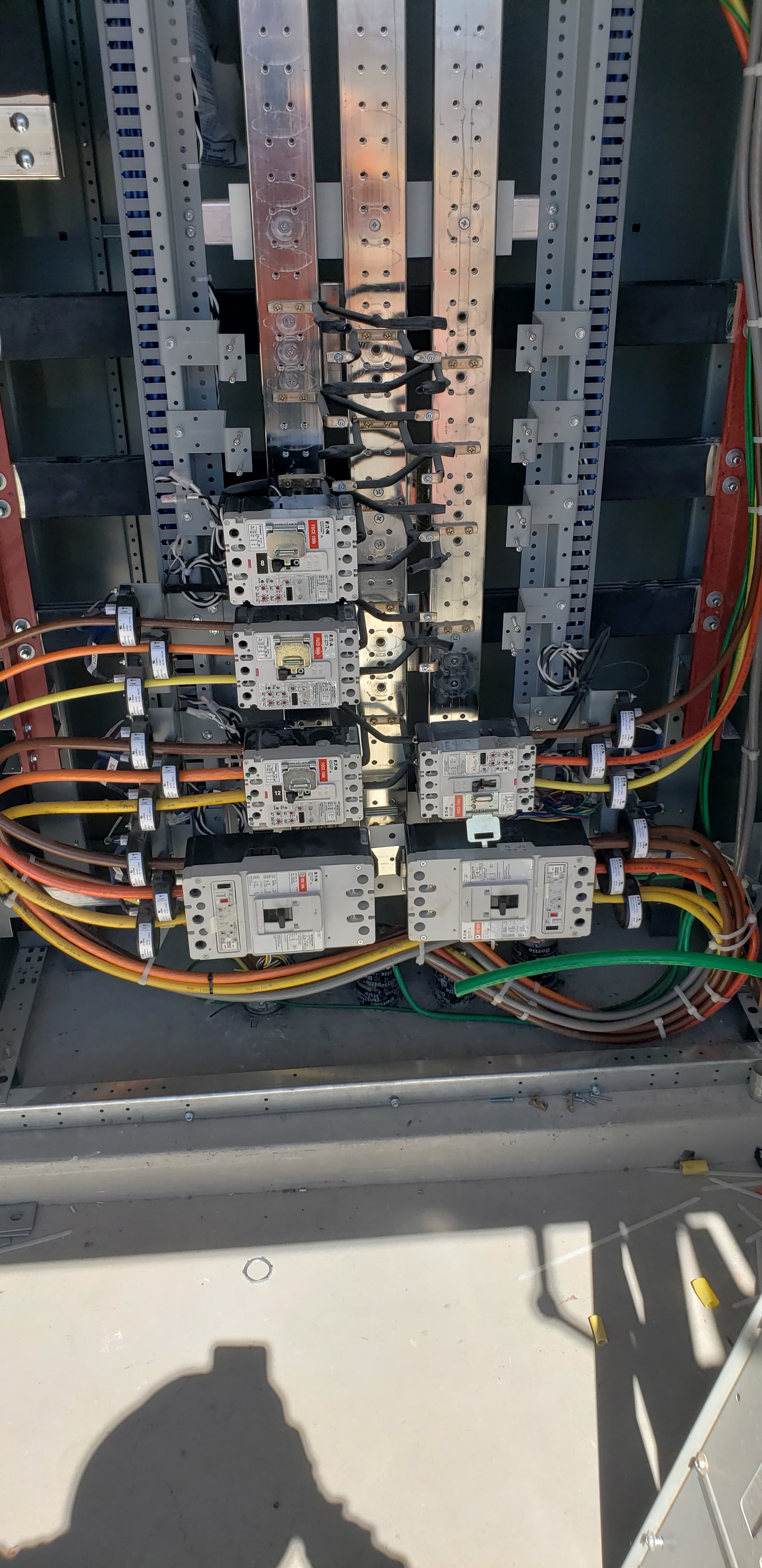 Commercial power distribution with multiple Eaton molded-case breakers and color-coded feeder conductors