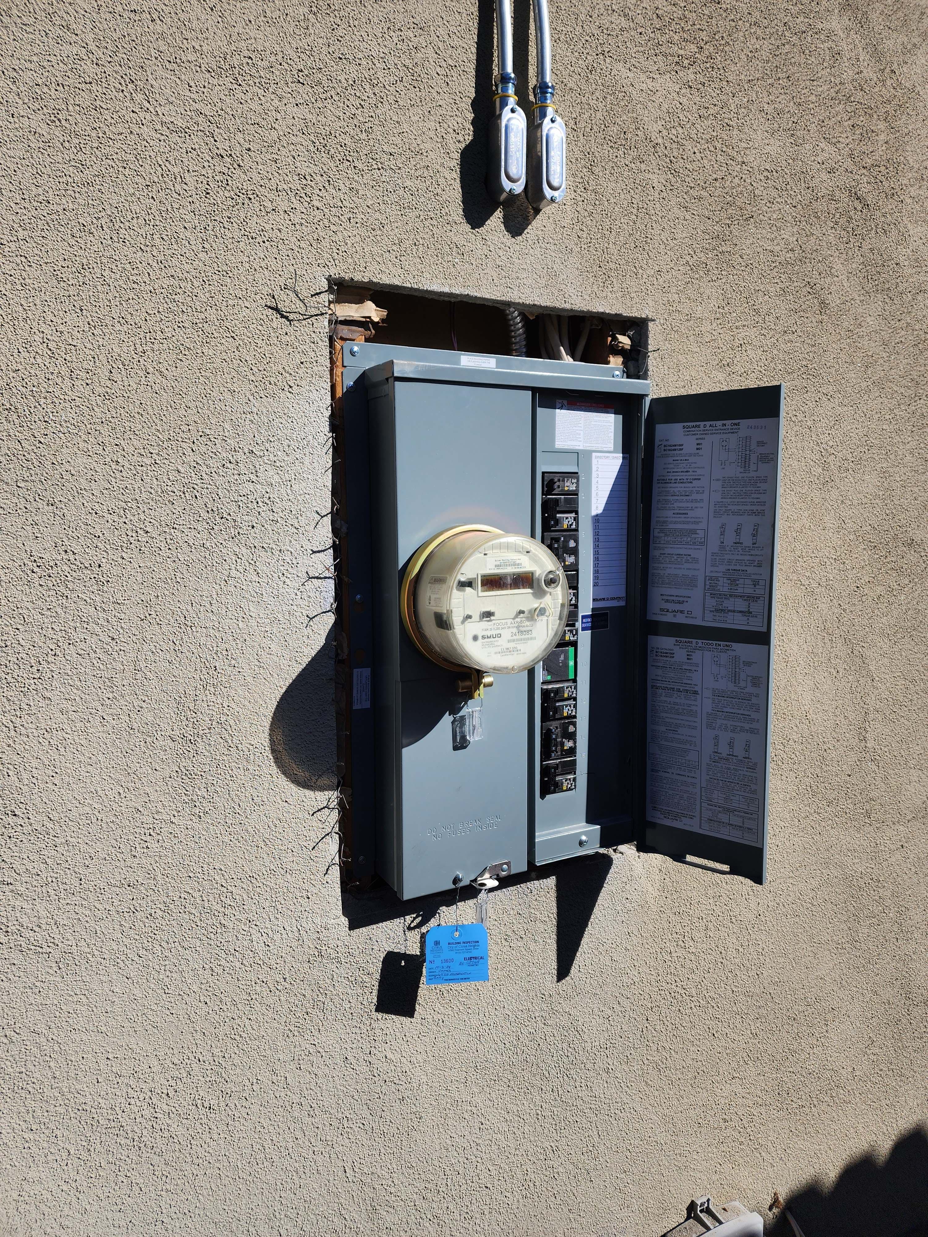 Exterior Square D all-in-one meter-main service upgrade with SMUD meter and a City of Citrus Heights electrical inspection tag